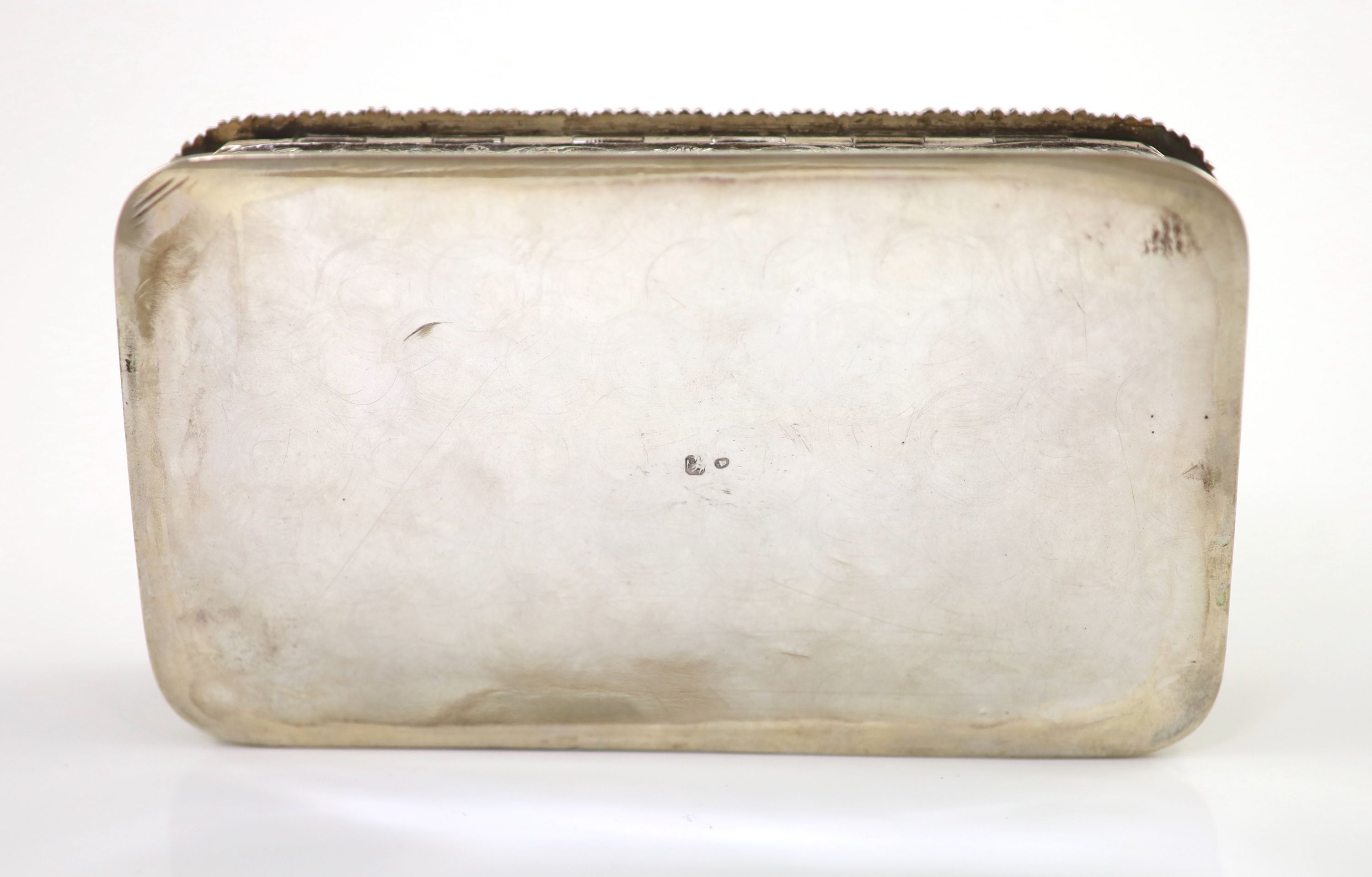 A 20th century Portuguese 833 standard silver rectangular box and cover, the lid cast and chased in high relief with travellers approaching a town,